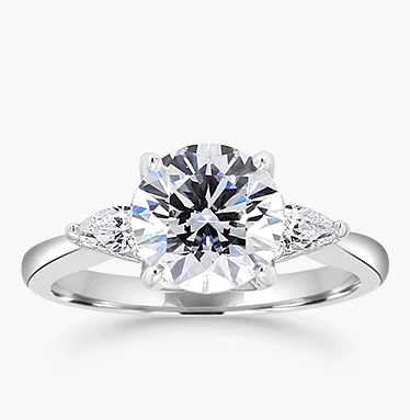 three stone diamond engagement ring with a round center diamond